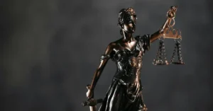 Bronze statue of Lady Justice holding scales and a sword, symbolizing fairness and the judicial system