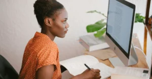 A woman completing an online questionnaire for their DUI alcohol assessment on a desktop computer, preparing for the evaluation process.