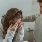 Child comforting a distressed mother during a difficult moment
