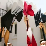 Graduates raising their caps in celebration