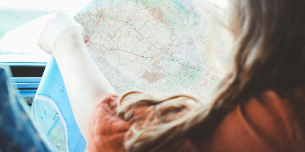 Person navigating with a road map