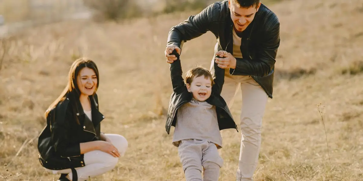 Happy family playing outdoors