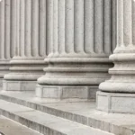 Front of stone courthouse columns and steps