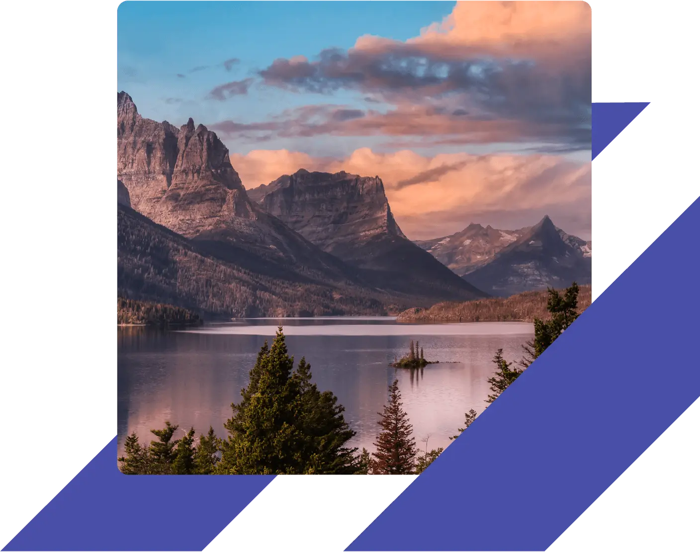 Scenic view of St. Mary Lake and Wild Goose Island in Glacier National Park, Montana, with dramatic mountain peaks and a vibrant sunset sky.