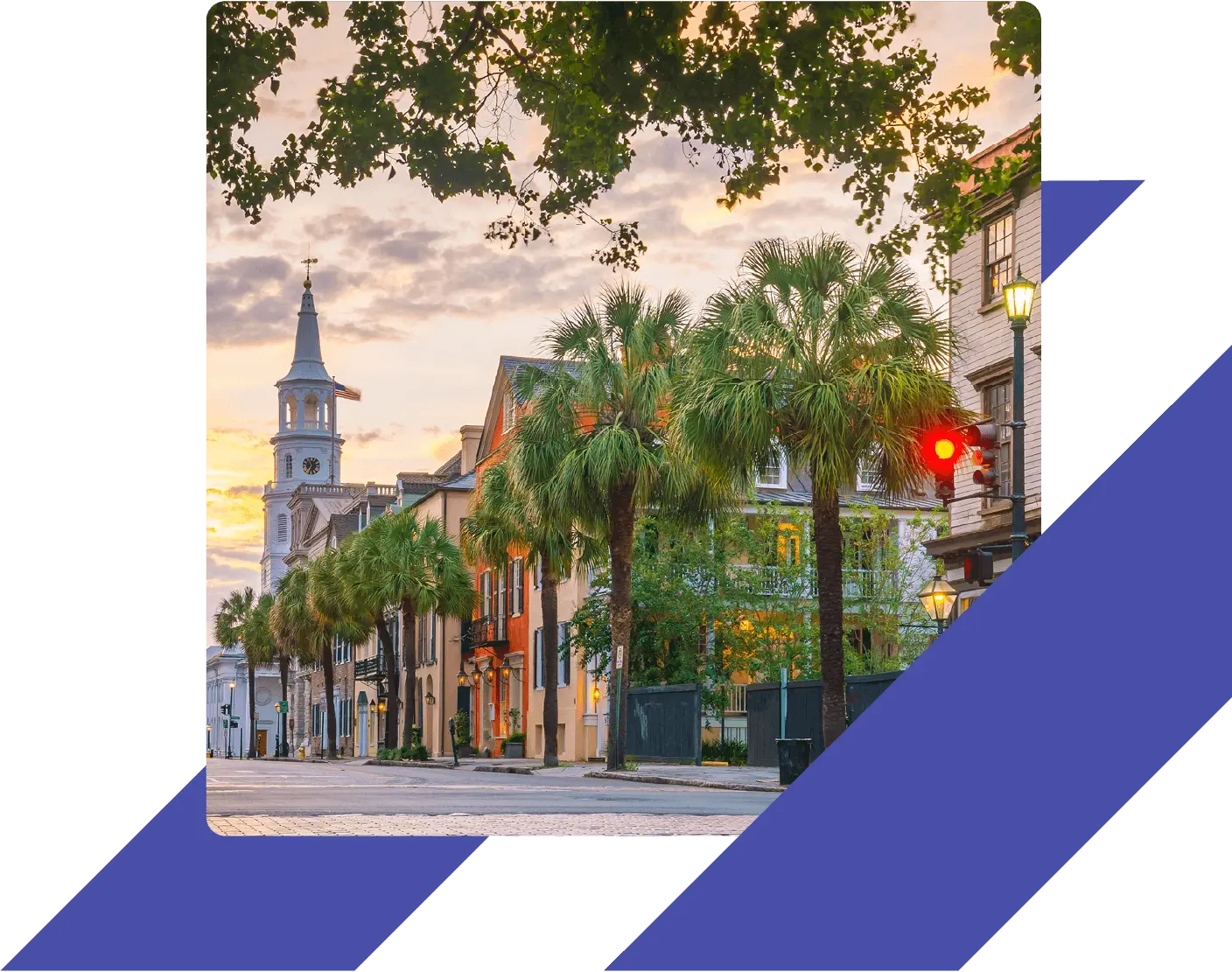 Historic downtown Charleston, South Carolina, at sunset with palm trees, colorful buildings, and the steeple of St. Michael’s Church in the background.