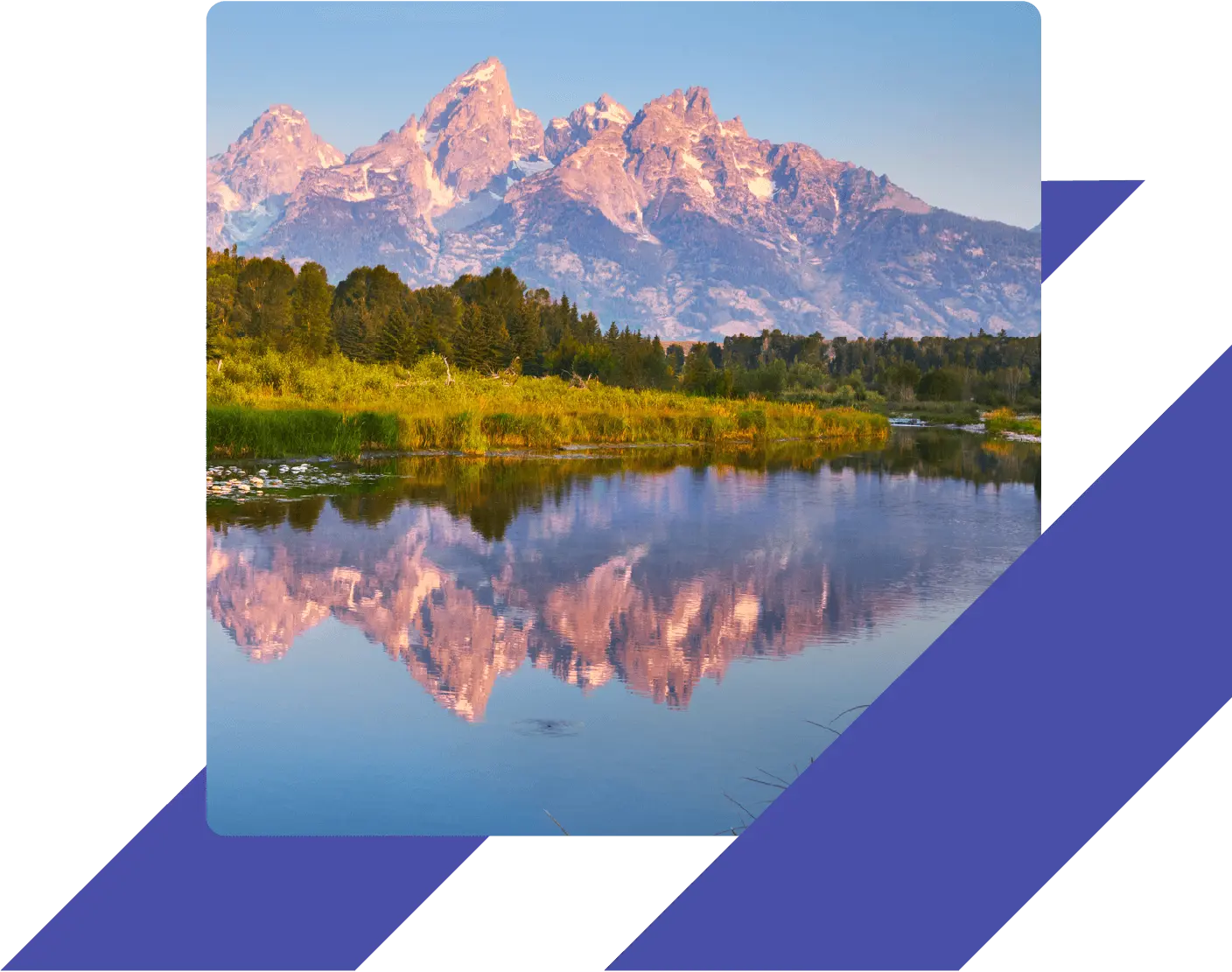 Snow-capped Teton Mountains reflected in the still waters of the Snake River at Schwabacher Landing in Grand Teton National Park, Wyoming.