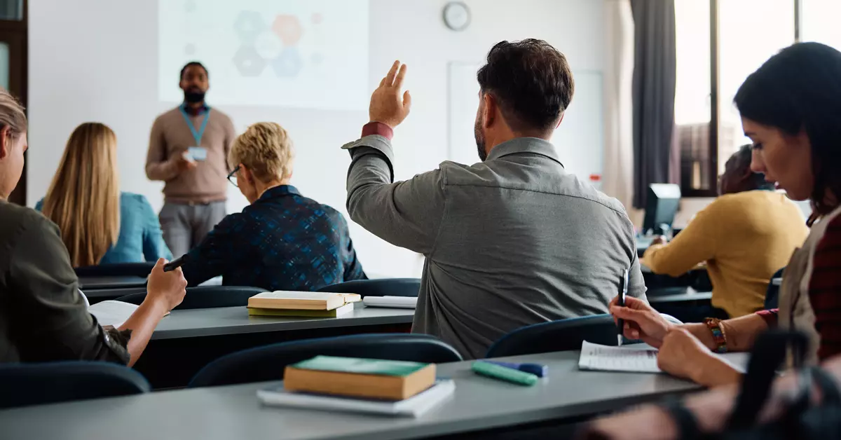 A picture of a classroom with people.