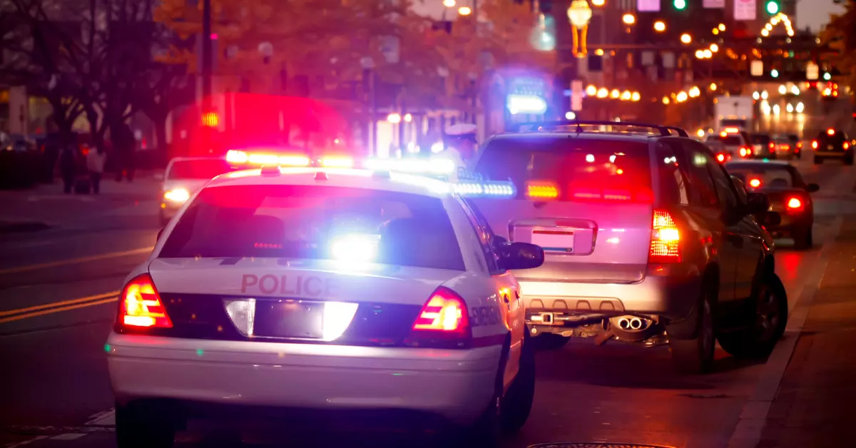 Image of a police car stopping another car.