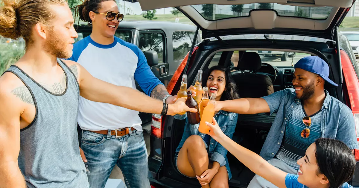 People tailgating and looking happy.