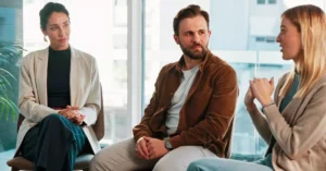 A group of people in meeting in an office.